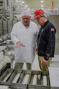 American Pan employee working with customer in pan production