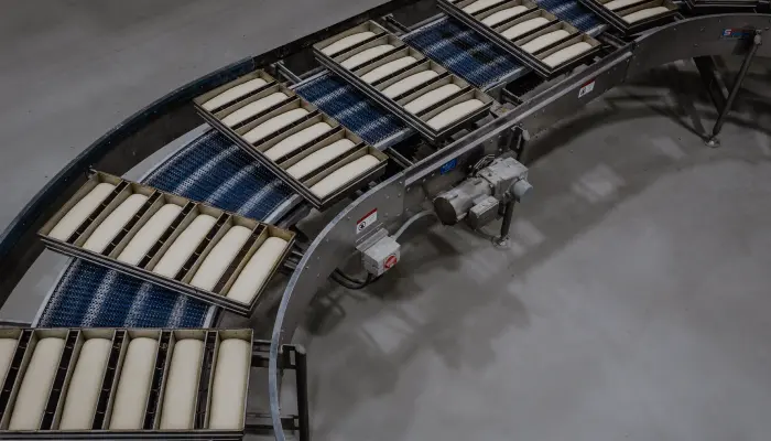 Industrial bread pans on bakery line